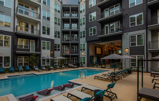 a swimming pool in front of an apartment building