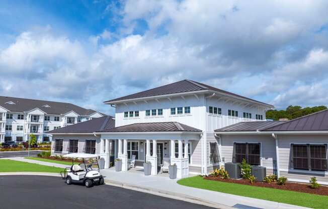 a large white building with a golf cart parked in front of it
