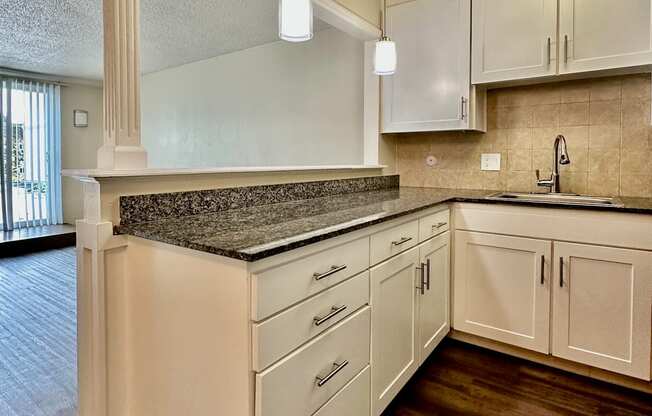 a kitchen with white cabinets and a counter top