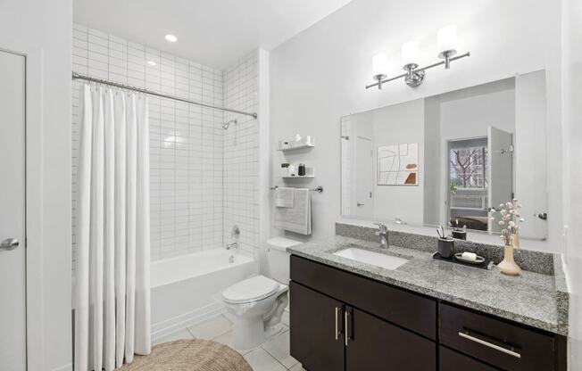 a white bathroom with a shower and a sink