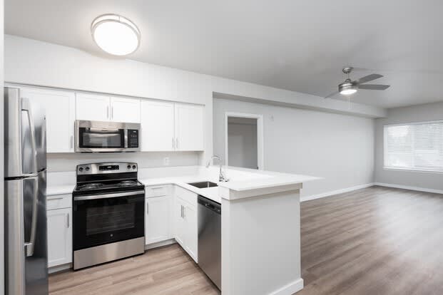 a kitchen with a stove top oven next to a refrigerator