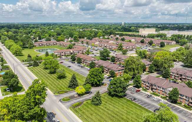 A suburban area with apartment buildings and a road.