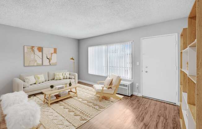 the living room of an apartment with a couch and a chair