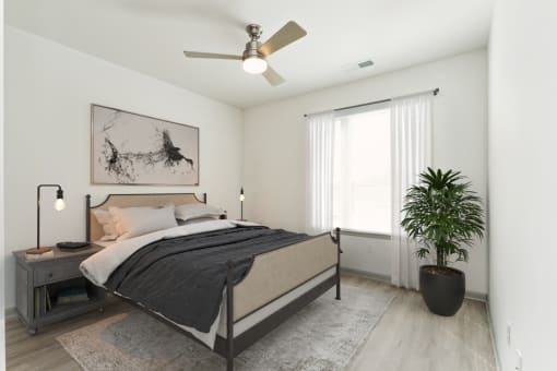 a bedroom with a bed and a ceiling fan at The Waterford At Rocketts Landing Apartments, PRG Real Estate, Richmond, Virginia