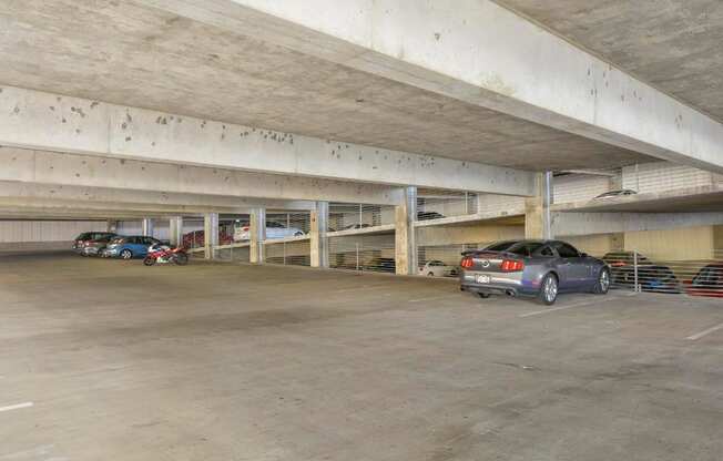 Private covered parking garage with overhead lighting.