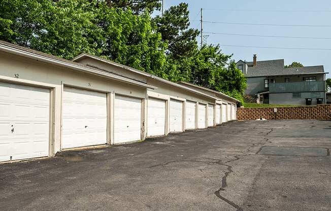 a row of white garages in front of a house