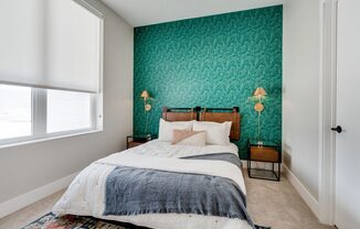 a bedroom with green wallpaper