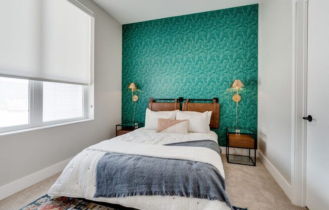 a bedroom with green wallpaper