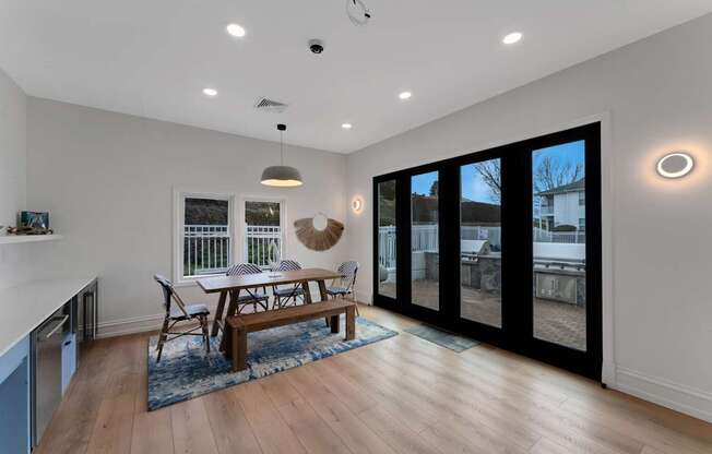 A modern living room with a wooden floor and a large window.