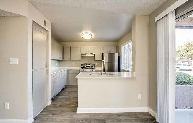 A kitchen with a white counter and stainless steel appliances at Sterling Point Apartment Homes, Phoenix, AZ, 85042