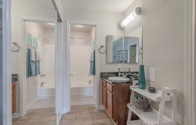 a bathroom with a sink and a mirror and a shower at City View Apartments at Warner Center, California, 91367