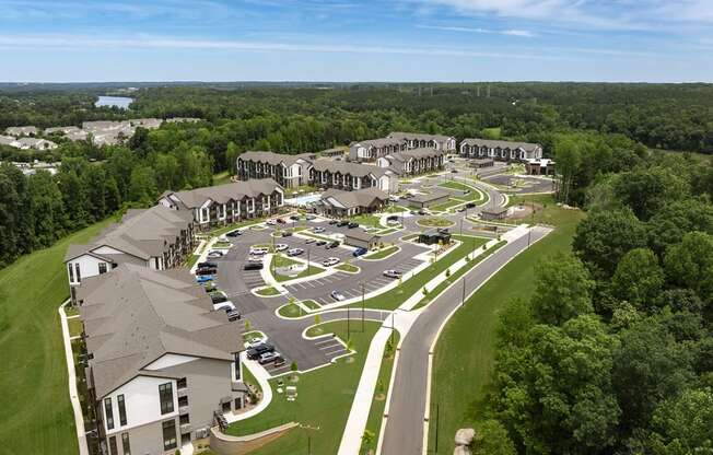 an aerial view of a resort with parking lot and buildings