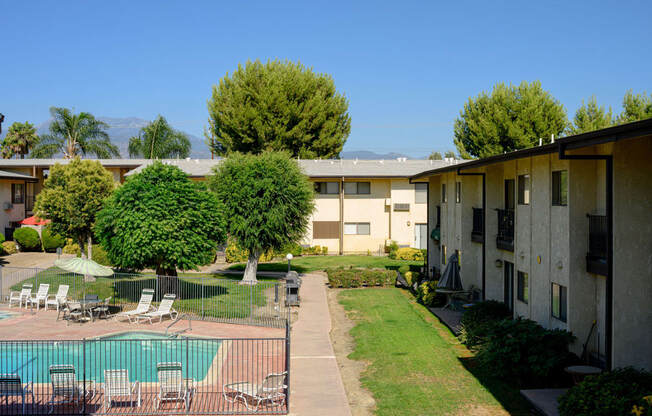 a view of the courtyard and pool at the whispering winds apartments in pearland, tx at Park Columbia Apts, Hemet, CA