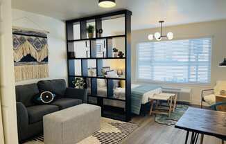 a living room and dining room with a couch and a table