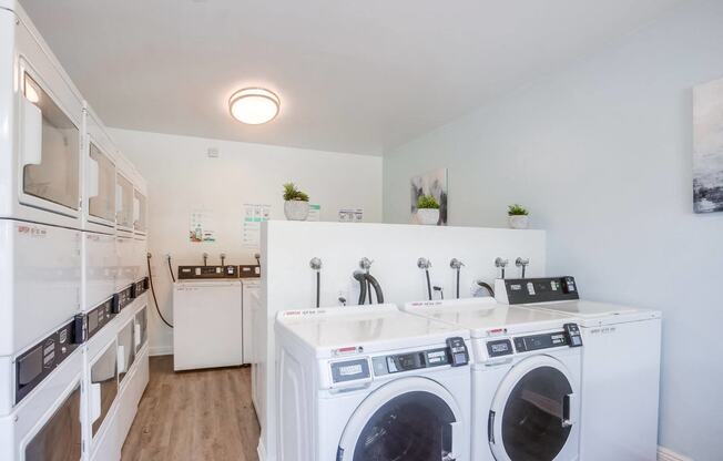 a washer and dryer in a laundry room with a sink and a counter