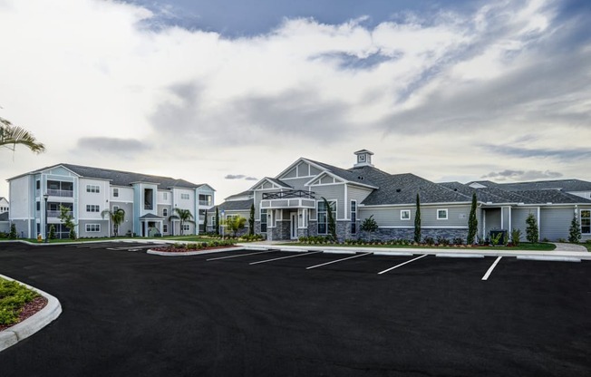 an empty parking lot in front of a large building