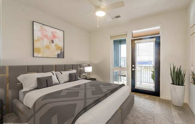a bedroom with a large bed and a door leading to a balcony