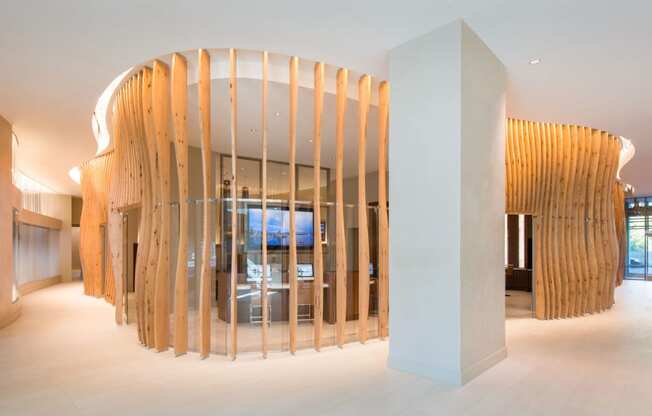 a large white pillar in the middle of a room with a wooden wall behind it and a at The Acadia at Metropolitan Park, Arlington