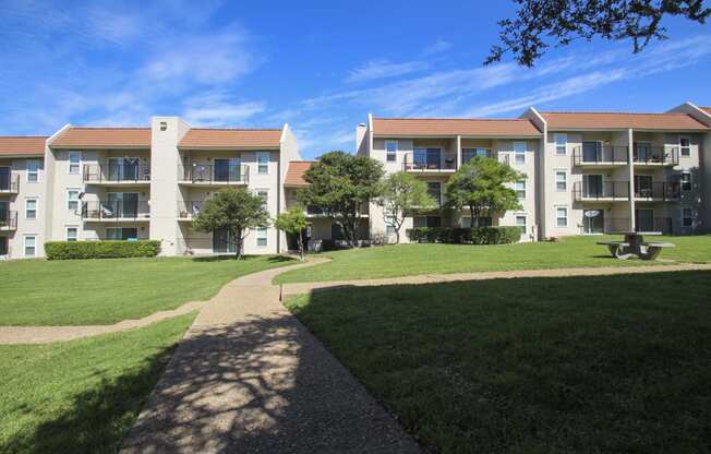 This is a photo of a courtyard and building exterior at Princeton Court Apartments in Dallas, TX