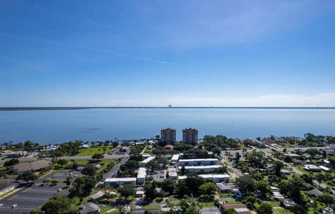 an aerial view of a city with a body of water