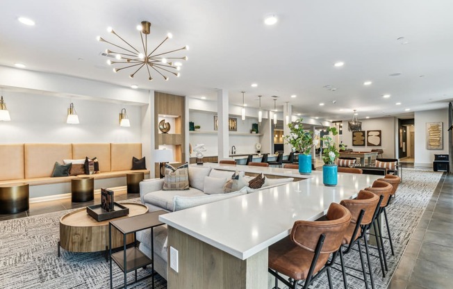 a living room with a long white communal table and chairs