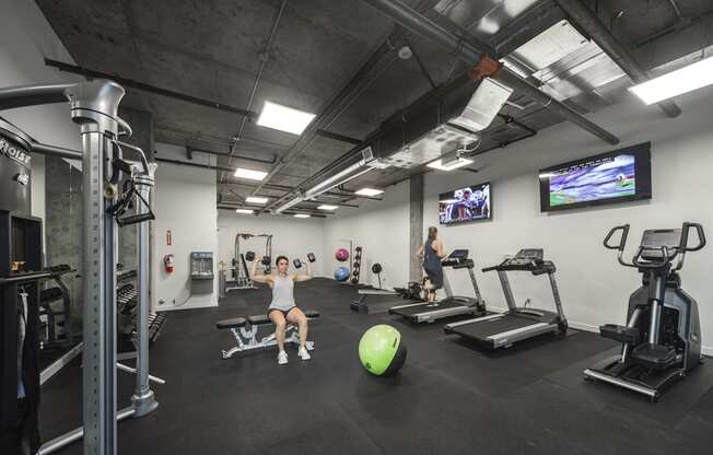 Gym with treadmills, an elliptical, weight machines, free weights, benches, an exercise ball and tvs at 6 Wood Flats, Lacey, WA