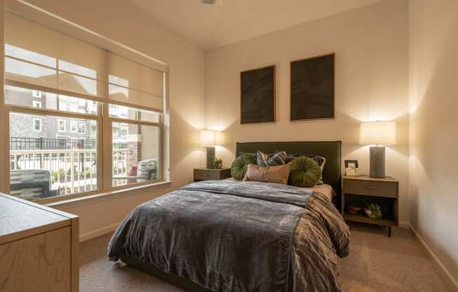 a master bedroom with a large window and a bed  at The Clearing at ONE28, Olathe, KS, 66062