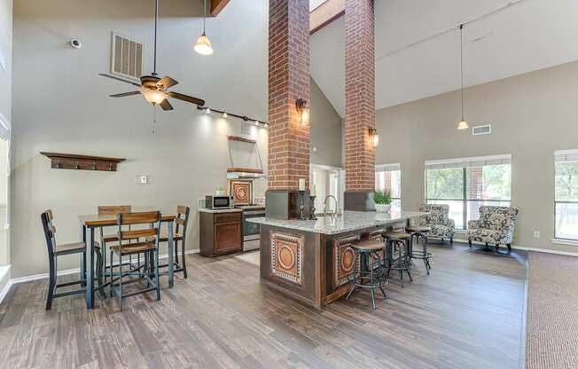 A kitchen with a bar and chairs.