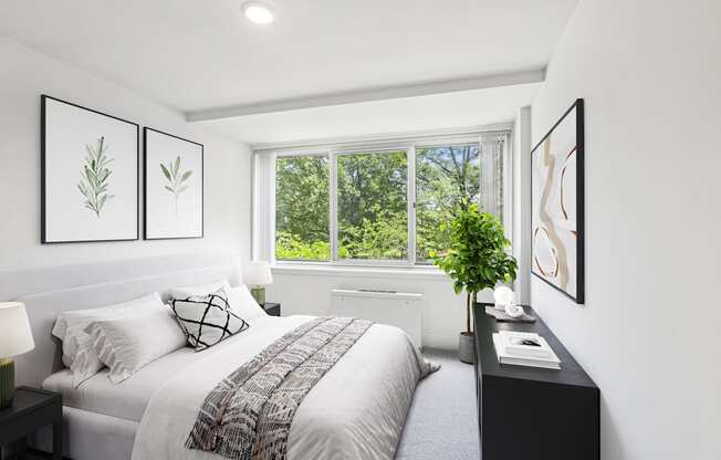 a bedroom with a bed and a large window