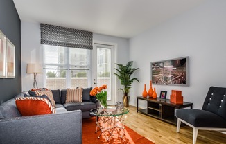 Living Room With Private Balcony at The Monarch, East Rutherford, NJ