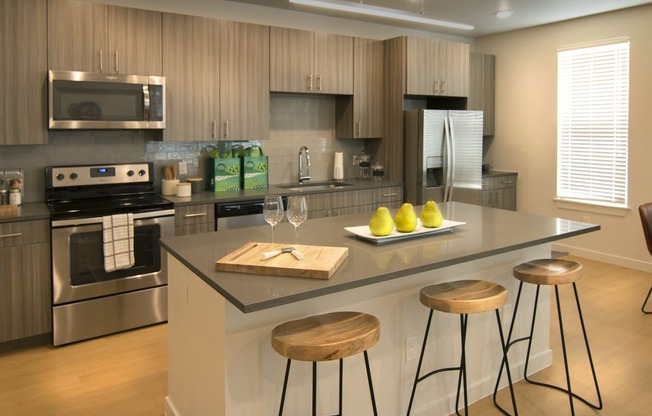 a kitchen with a center island with three stools