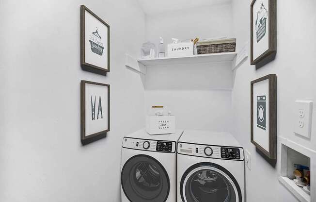 Two front load washing machines in a laundry room.