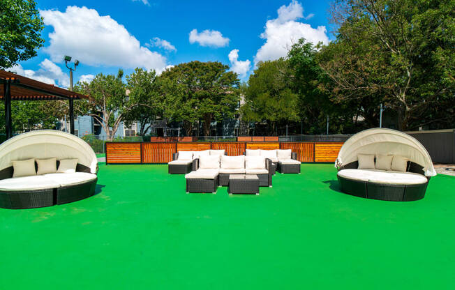 a seating area with couches on a green carpet