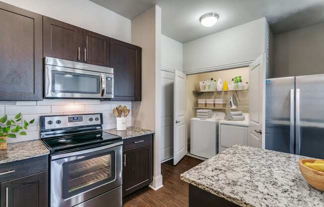 a kitchen with stainless steel appliances and granite counter tops