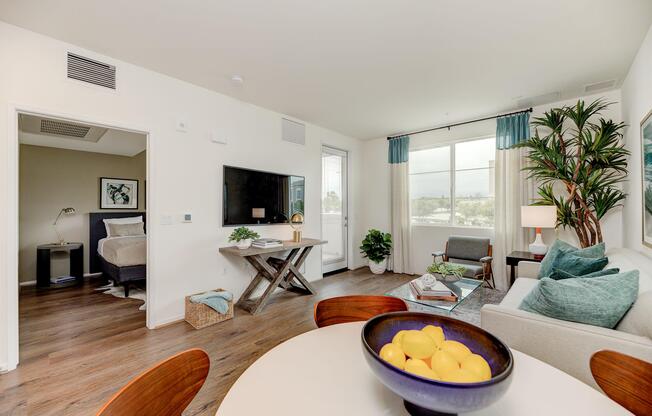 a living room filled with furniture and a large window