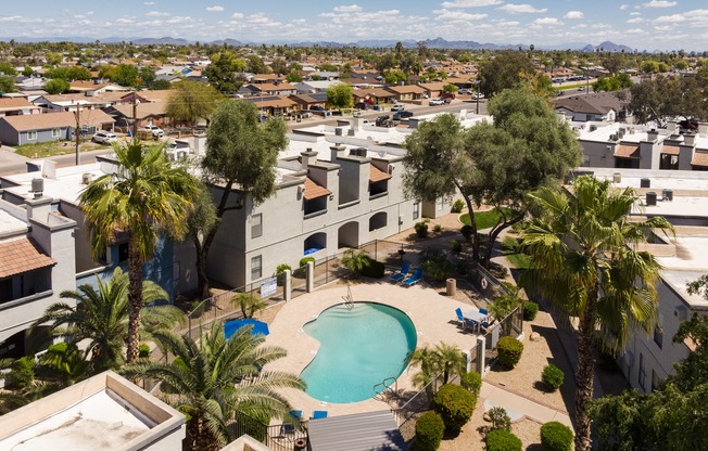 an aerial view of a community with a pool and palm trees