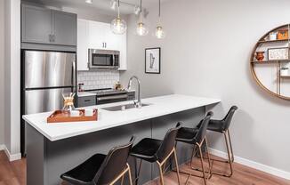 Modern kitchen with granite countertops at The Harper