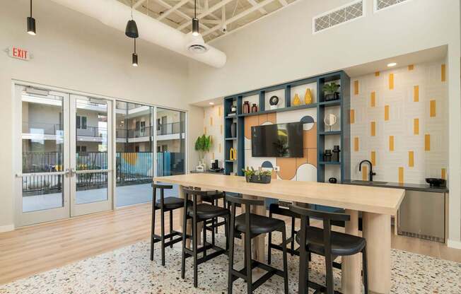 A kitchen with a bar area and a dining table.