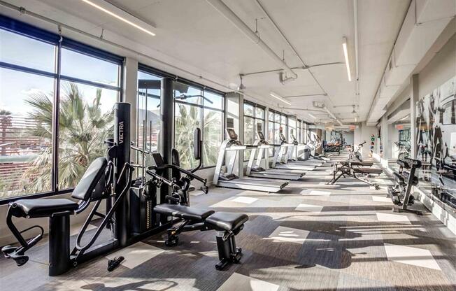 Upgraded gym with a lot of exercise equipment and large windows