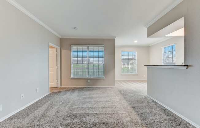 the spacious living room and dining room in a new home