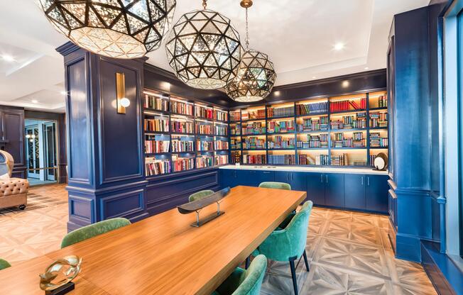 The library at Modera Old Ivy features a polished conference table setting for focused work or intimate gatherings in Atlanta.