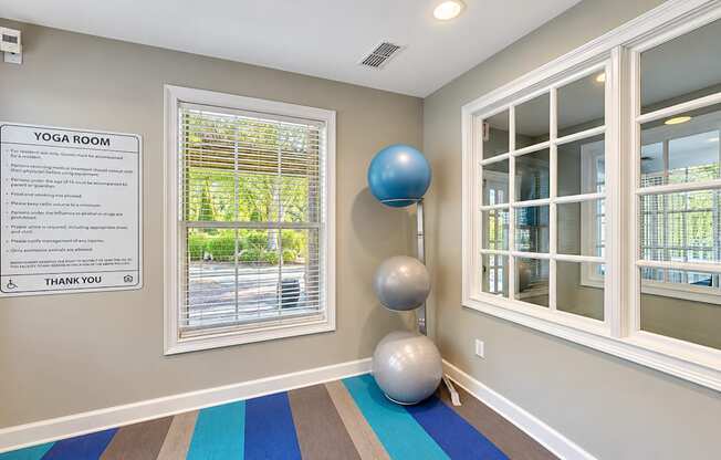 Yoga room with exercise balls, striped flooring, and interior windows at Elevation 3505 in Atlanta, GA.