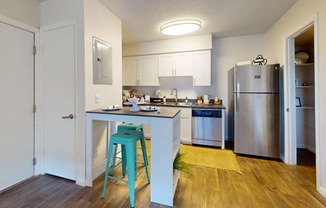 a kitchen with a blue counter top and a stainless steel refrigerator