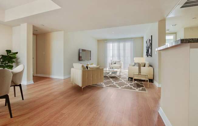 a living room and dining room with a hard wood floor