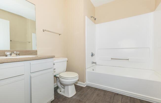 a white tub sitting next to a sink