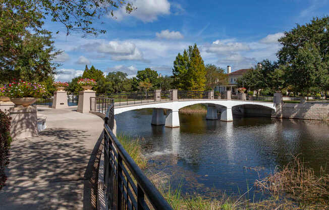 A bridge over a river with a walkway on the left side.