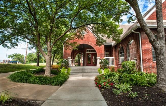 a brick building with trees in front of it