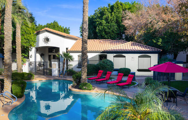 A pool with a building behind it.