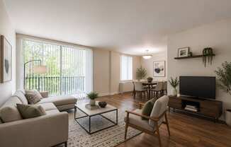 A living room with a couch, chairs, and a coffee table.