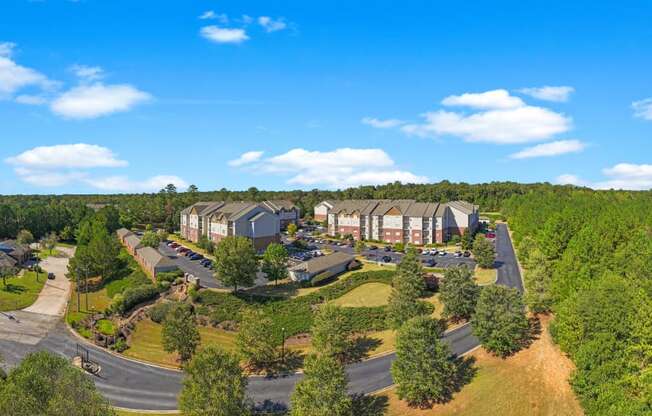an aerial view of a resort with trees and houses